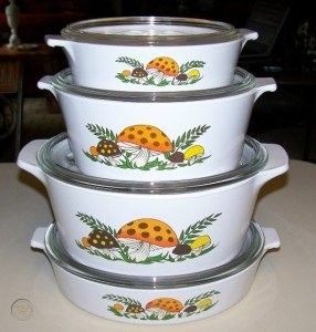 Stacked white casserole dishes with an orange mushroom pattern