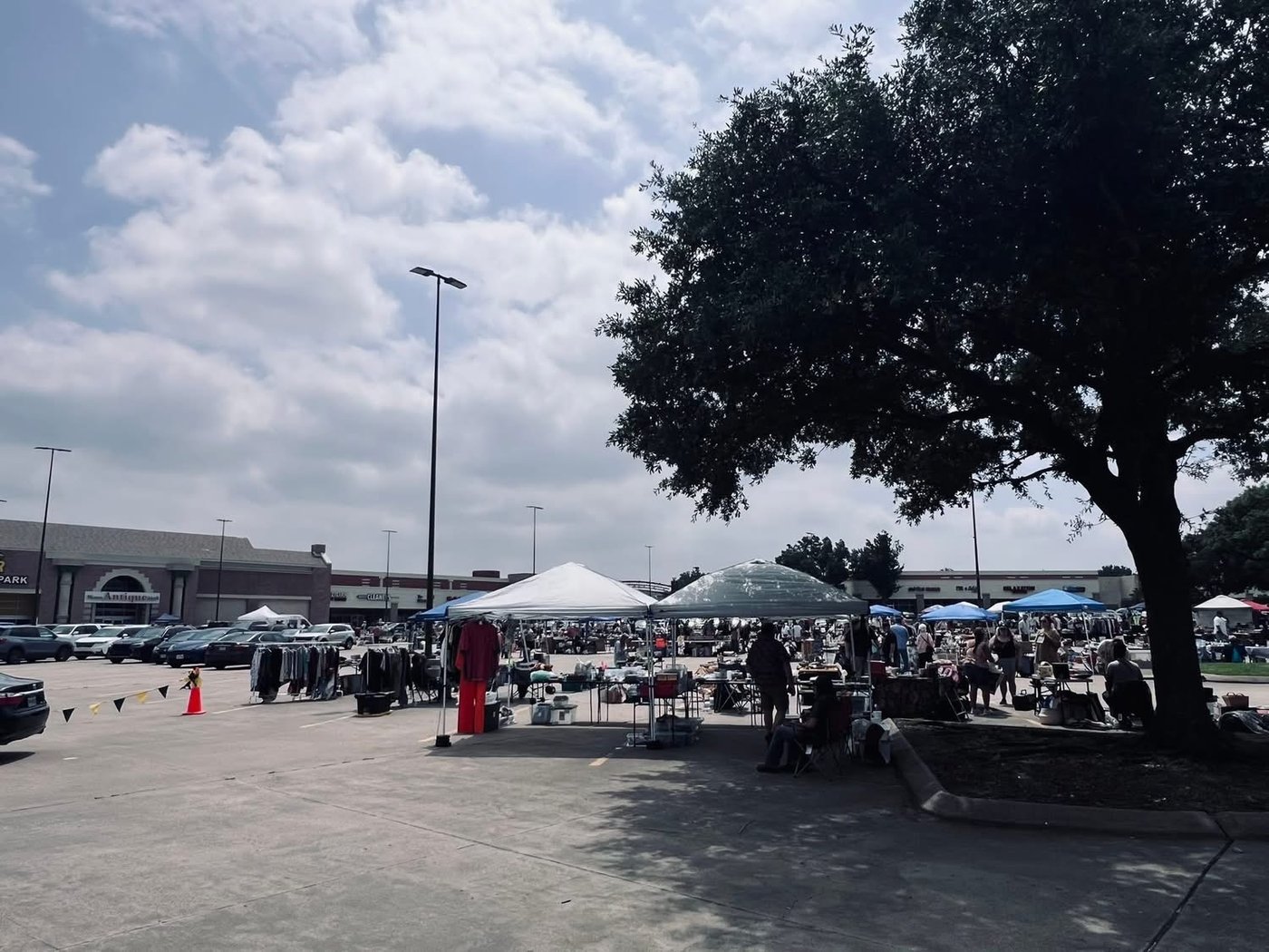 Rows of vendor tents in the Plano Antique Mall parking lot on a sunny day