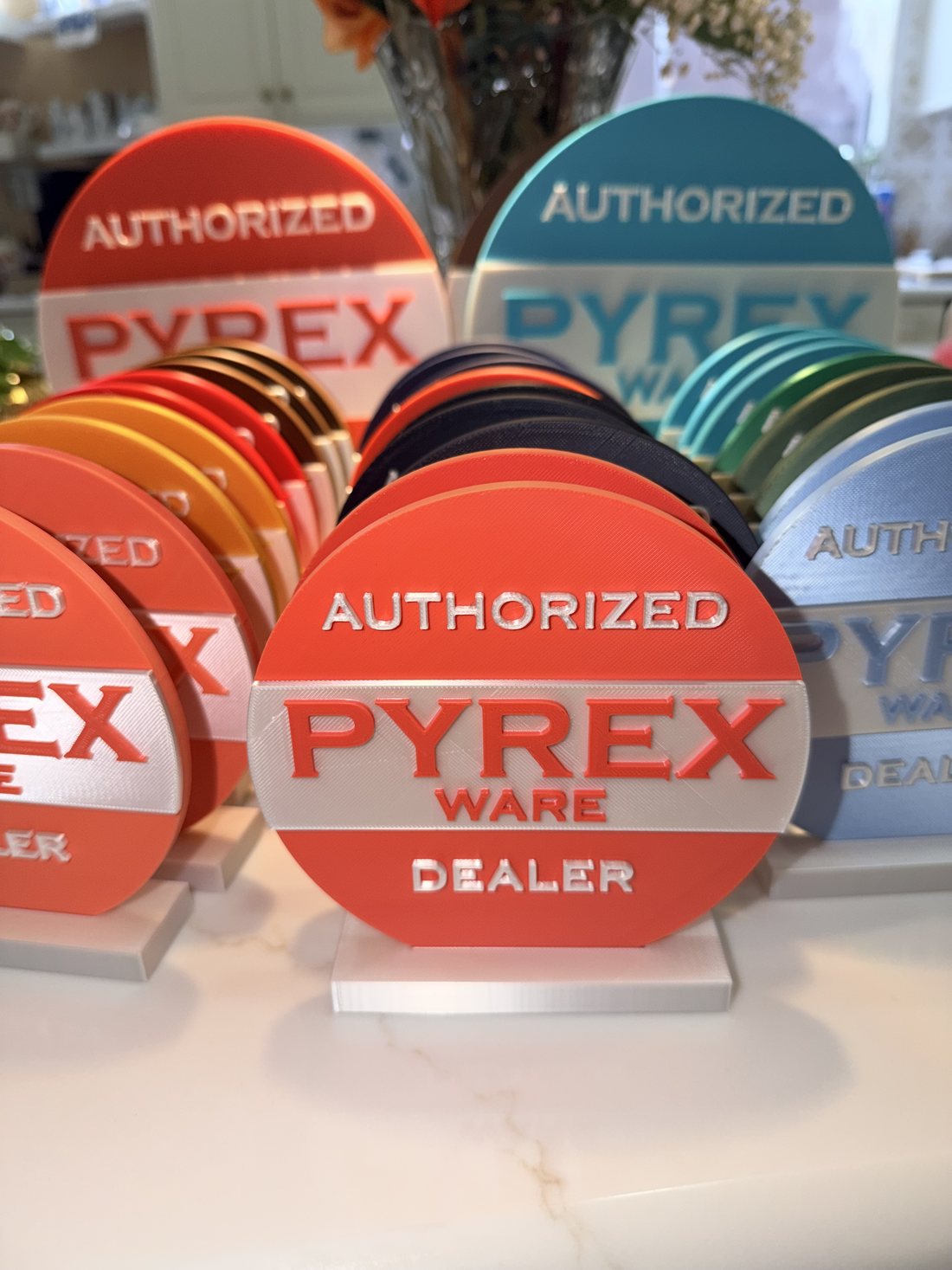 Coral and blue Authorized Pyrex Ware Dealer display signs