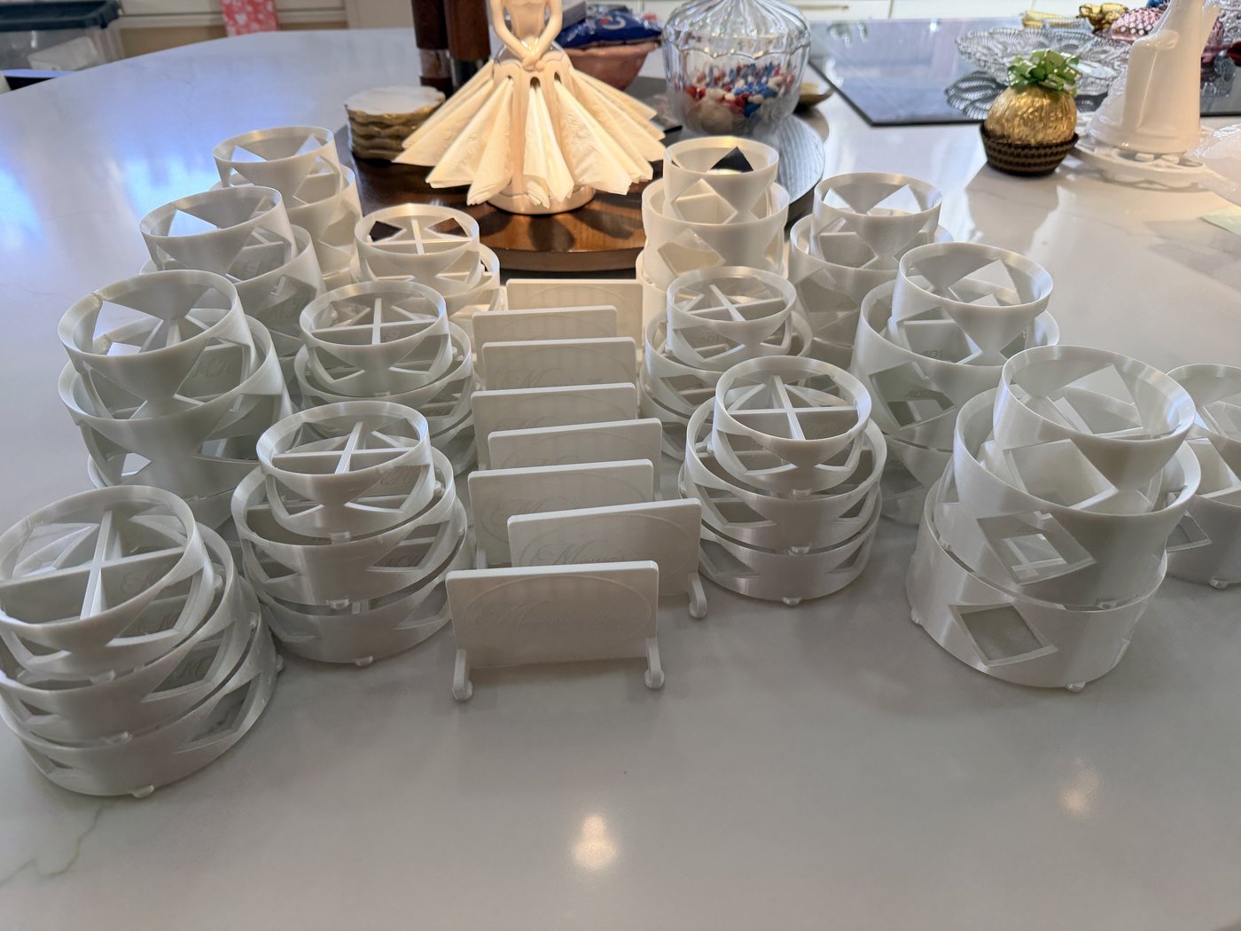 White Marissa's Home Pyrex risers with diamond cutouts, stacked by size, with butter dish display stands in the middle